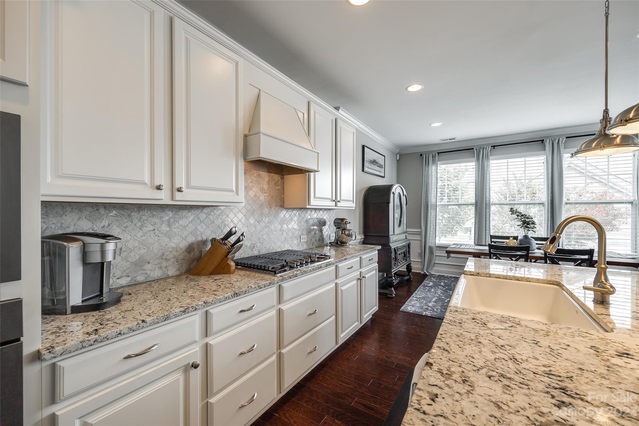 201 Helton Lane Fort Mill, SC 29708 - Photo 18 of 47 a kitchen with granite countertop a stove sink and cabinets