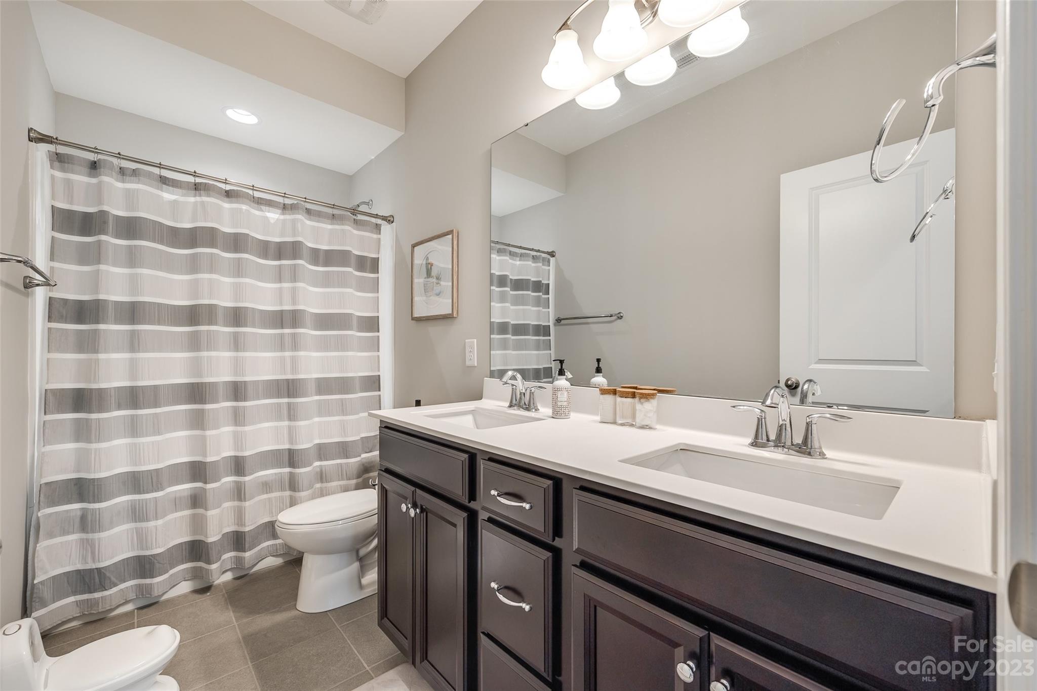 201 Helton Lane Fort Mill, SC 29708 - Photo 27 of 47 a bathroom with a sink a toilet a mirror and shower curtain