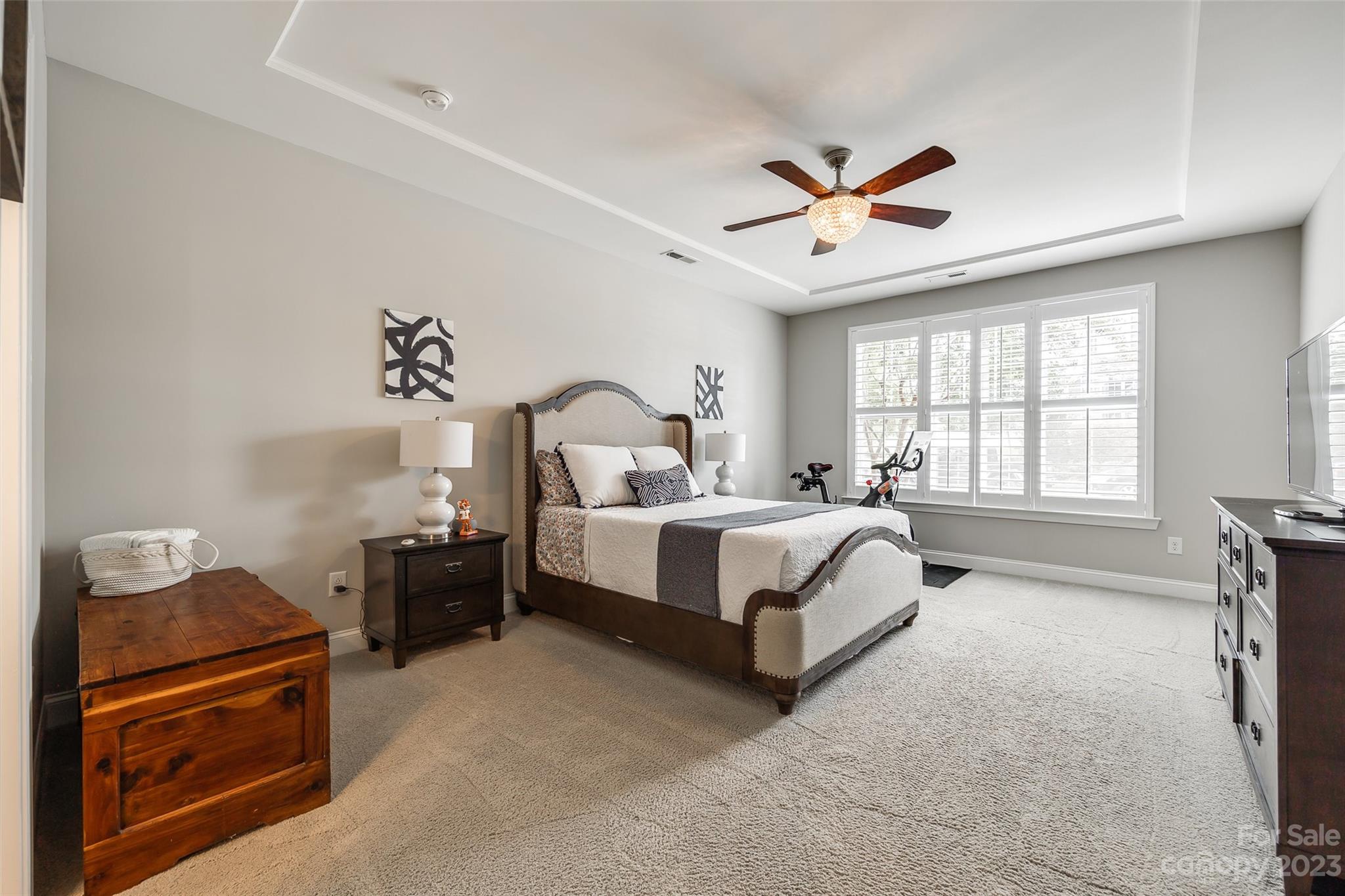 201 Helton Lane Fort Mill, SC 29708 - Photo 8 of 47 a spacious bedroom with a bed and a chandelier