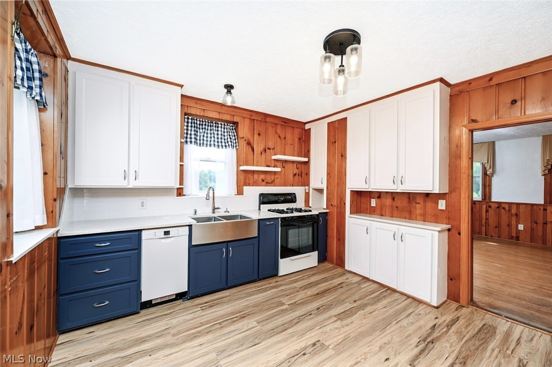 2559 Raber Road Uniontown, OH 44685 - Photo 18 of 41 *KITCHEN W/NAVY LOWER SOFT CLOSE CABINETS, WHITE TALL UPPER CABINETS, SUBWAY TILE BACKSPLASH, PANTRY, SPECKLED GLASS LIGHTING, FARMHOUSE SINK AND LUXURY PLANK FLOORING ~