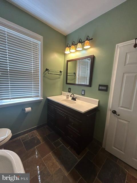 306 Kingston Road Baltimore, MD 21229 - Photo 13 of 17 a bathroom with a sink toilet and mirror