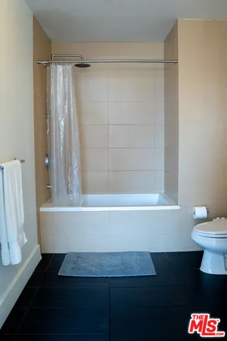 a view of kitchen with a stove a mirror and cabinets
