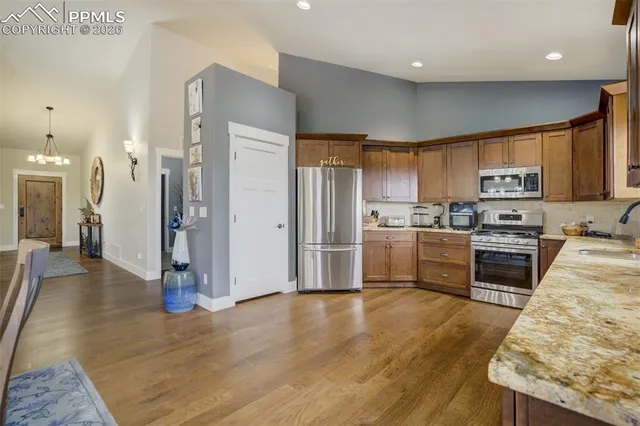 a kitchen with granite countertop stainless steel appliances and wooden cabinets