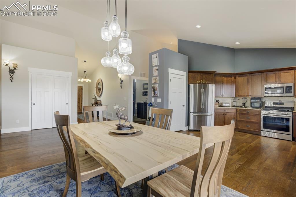 57 Cradle Lake Place Divide, CO 80814 - Photo 12 of 48 a view of a dining room and livingroom with furniture wooden floor a rug a chandelier
