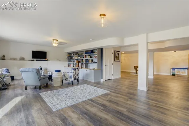 a living room with furniture and wooden floor