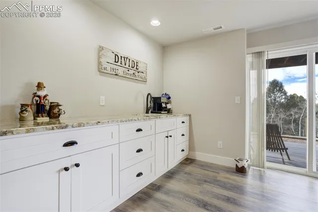a kitchen with sink cabinets and wooden floor