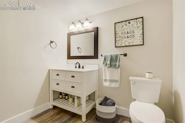 a bathroom with a toilet a sink and mirror