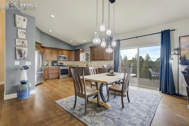 a dining room with furniture a chandelier and wooden floor