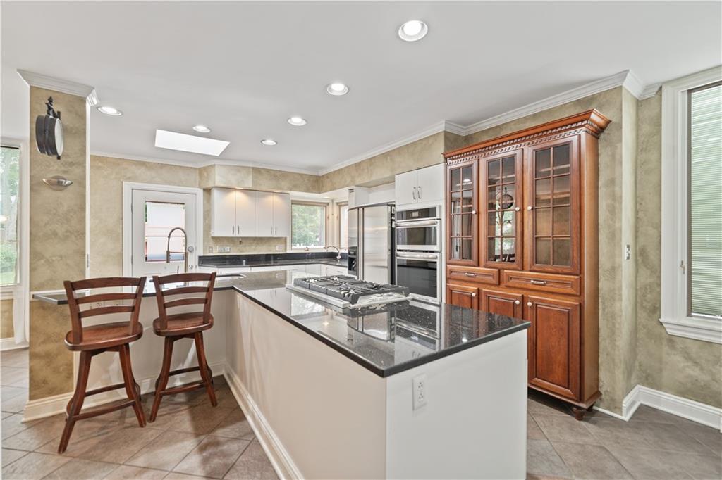 460 2nd Street Beaver, PA 15009 - Photo 19 of 50 Large Kitchen Island with NEW Gas Cooktop with Pop Up Vent, Granite Countertops. No Shortage of Prep and Storage Space.