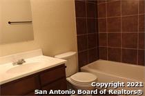 16802 Showdown Path, Unit 3 Selma, TX 78154 - Photo 12 of 22 a bathroom with a sink a toilet and a mirror
