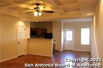 16802 Showdown Path, Unit 3 Selma, TX 78154 - Photo 2 of 22 a view of a hallway with wooden floor and a chandelier