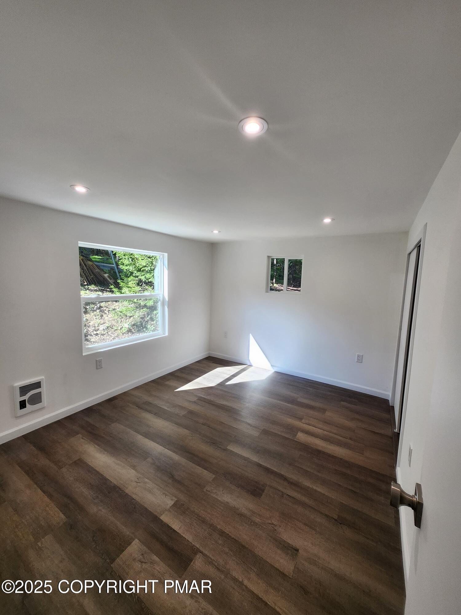 386 Hunters Farm Road Henryville, PA 18332 - Photo 12 of 18 an empty room with wooden floor and windows