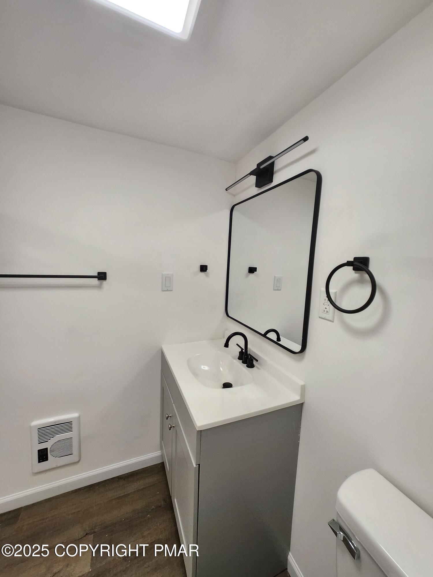 386 Hunters Farm Road Henryville, PA 18332 - Photo 17 of 18 a bathroom with a sink mirror vanity and toilet