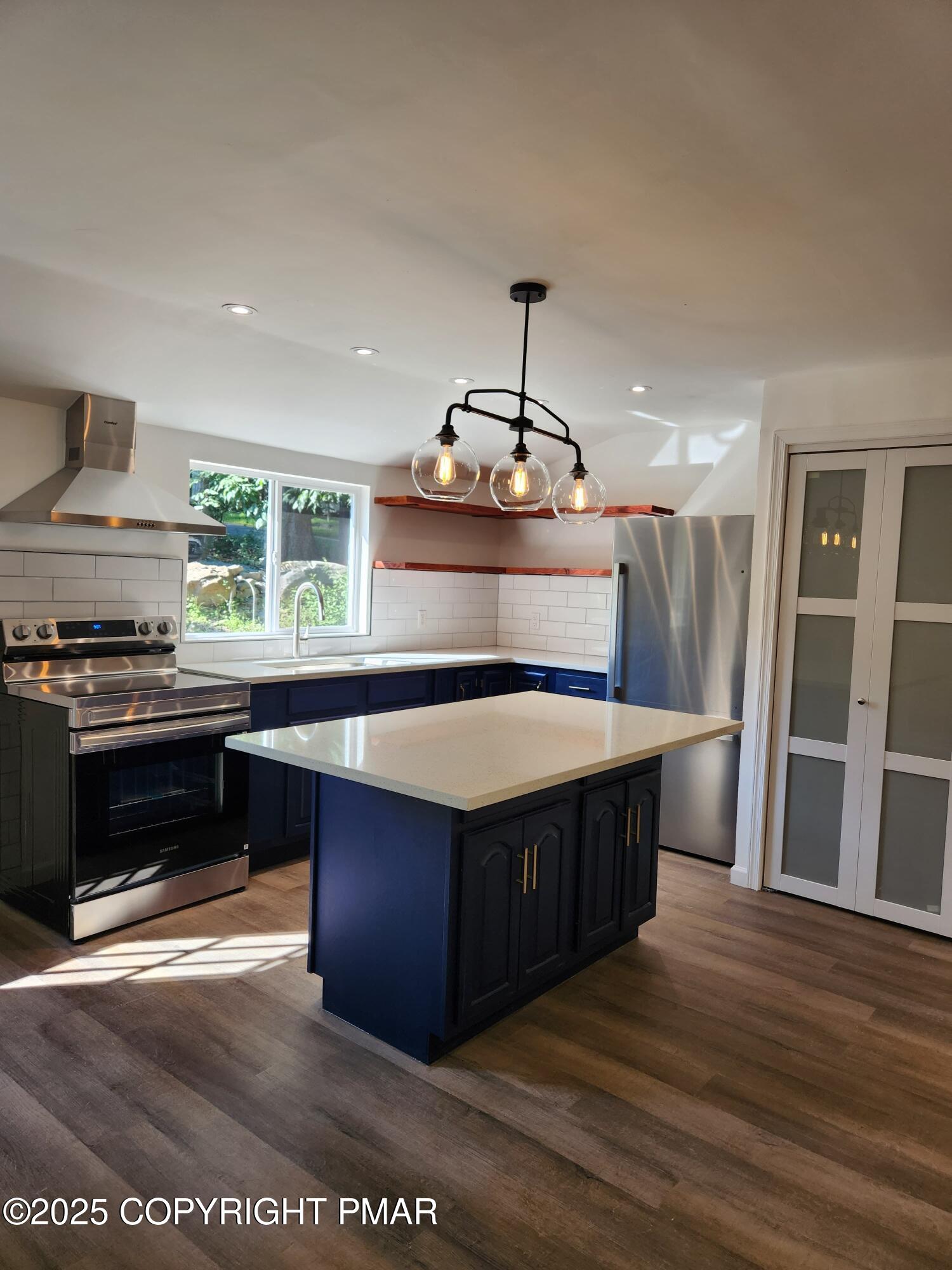 386 Hunters Farm Road Henryville, PA 18332 - Photo 9 of 18 a kitchen with stainless steel appliances granite countertop a stove and a wooden floor