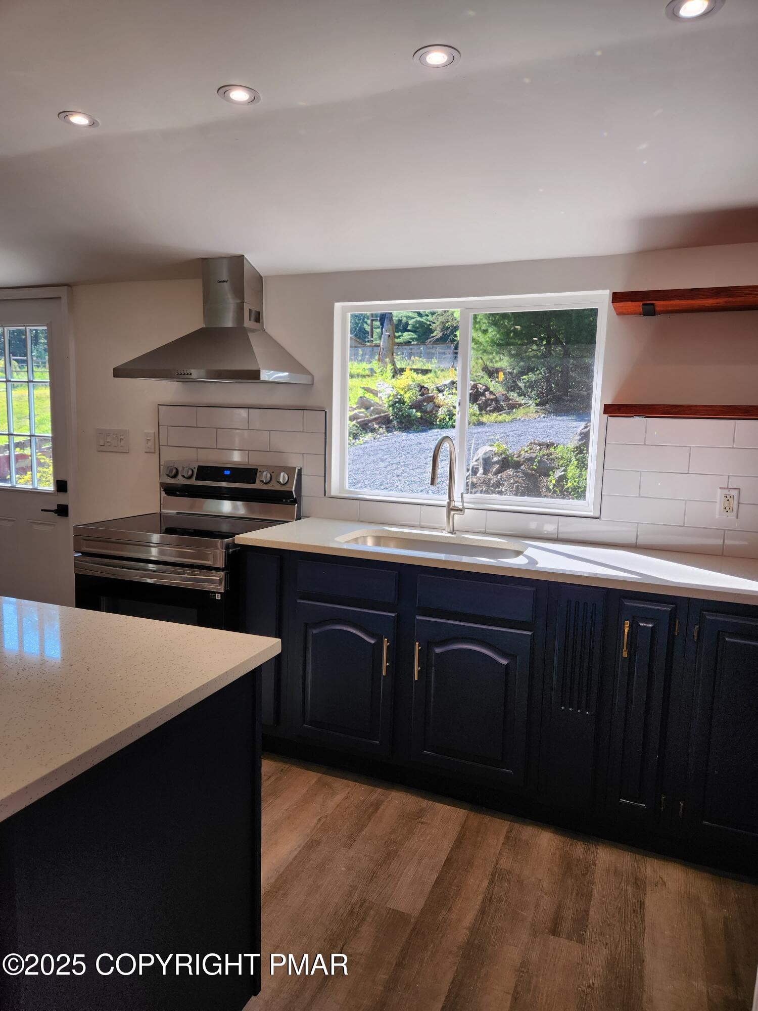 386 Hunters Farm Road Henryville, PA 18332 - Photo 10 of 18 a kitchen with kitchen island granite countertop a sink appliances and cabinets