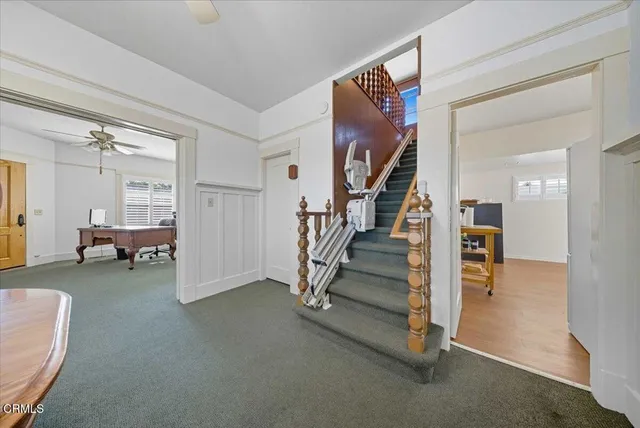 a view of a livingroom with furniture and staircase