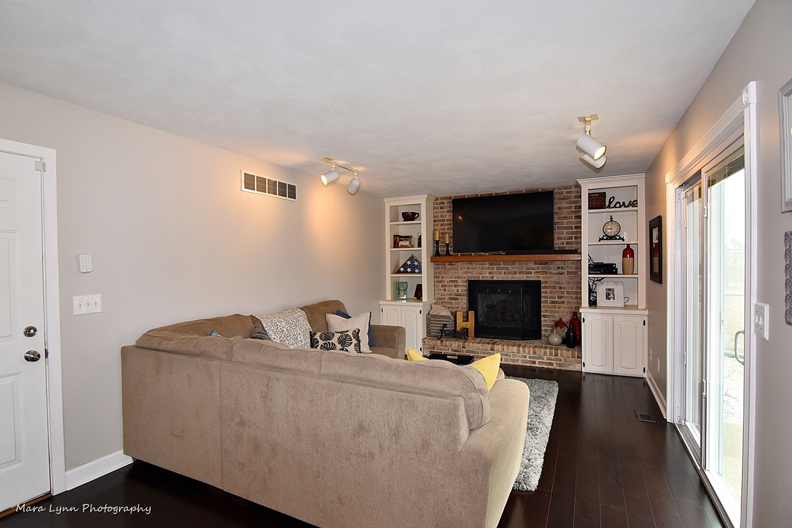2667 Blackman Road Geneva, IL 60134 - Photo 11 of 17 a living room with furniture a flat screen tv and a fireplace