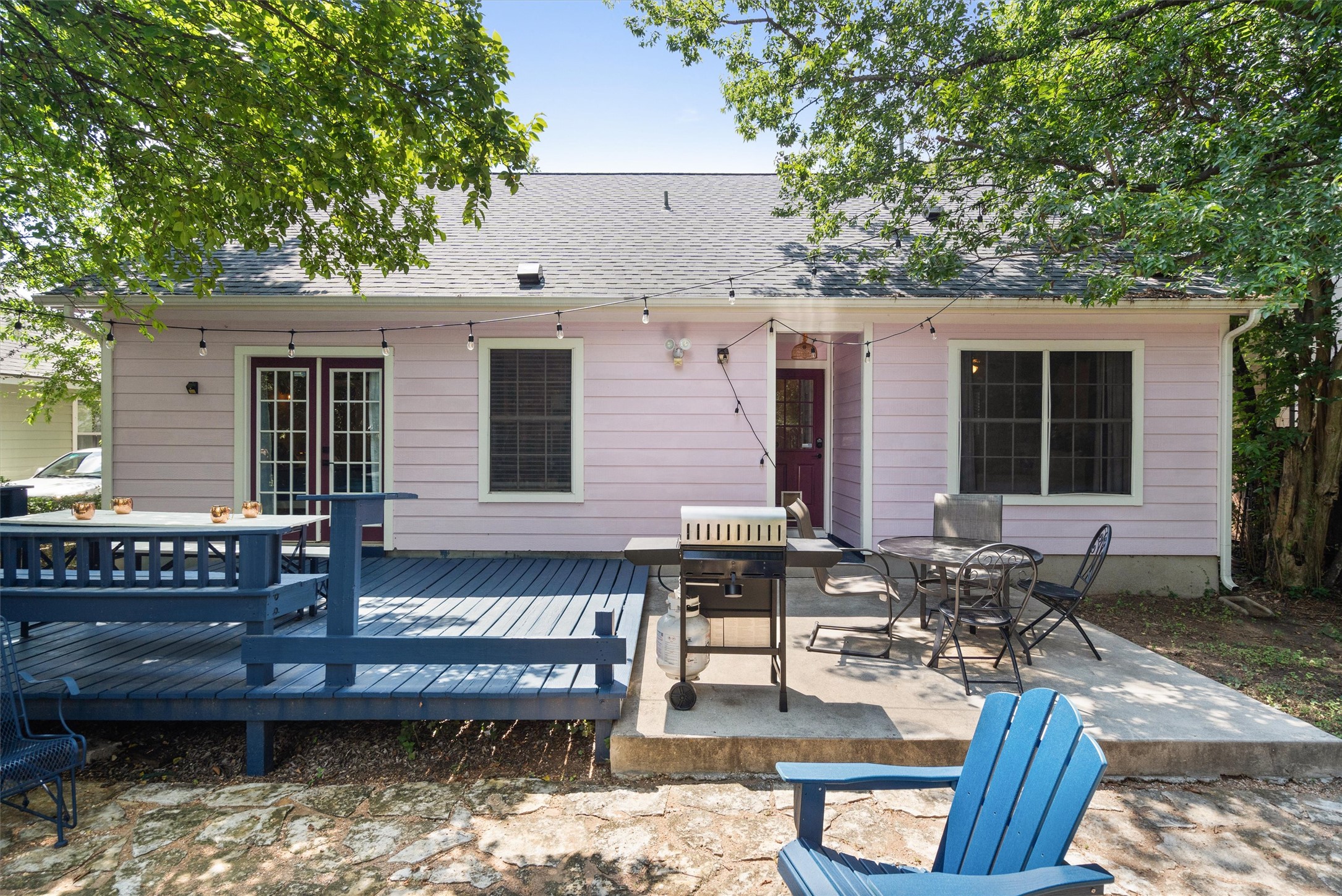 1407 Sanchez Street Austin, TX 78702 - Photo 27 of 34 Back of house featuring outdoor dining space, roof with shingles, a patio area, and a deck