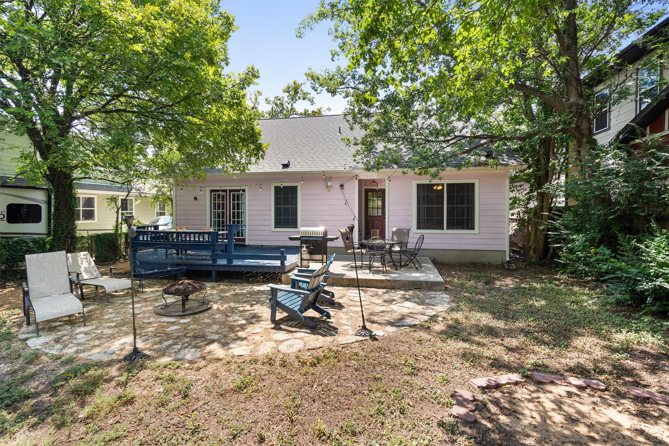 1407 Sanchez Street Austin, TX 78702 - Photo 30 of 34 Rear view of property featuring a patio area, a fire pit, a deck, roof with shingles, and outdoor dining space