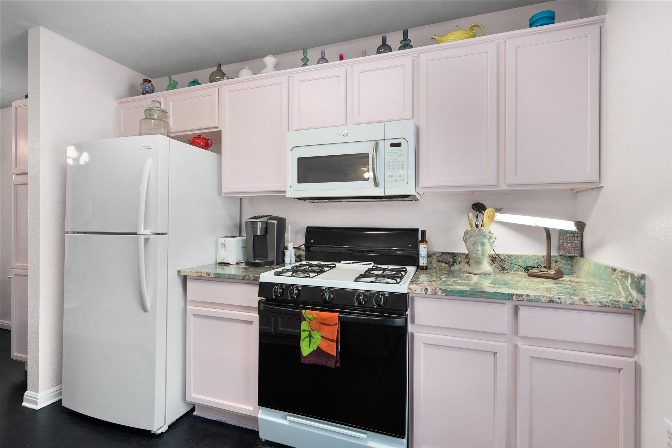 1407 Sanchez Street Austin, TX 78702 - Photo 10 of 34 Kitchen featuring white appliances, light stone countertops, and white cabinets