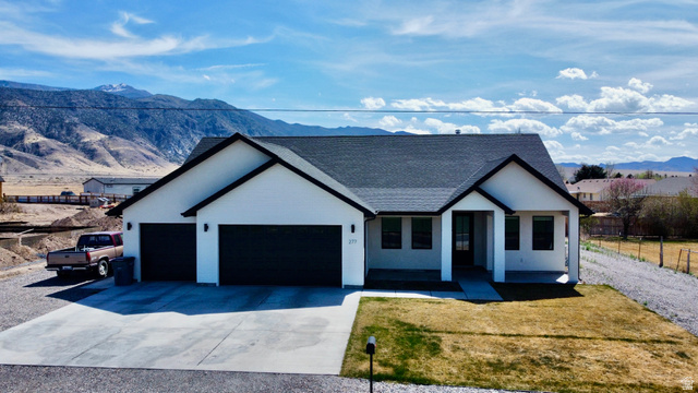 277 West 800 South Monroe, UT 84754 - Photo 36 of 46 Modern farmhouse style home with a mountain view, a shingled roof, a garage, and driveway