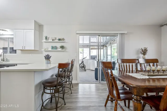 a view of a dining room with furniture and wooden floor