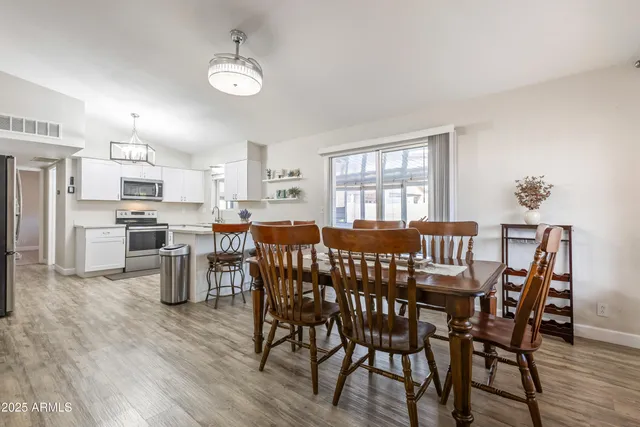 a view of a dining room with furniture and wooden floor