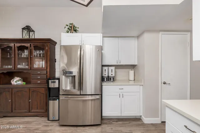 a kitchen with stainless steel appliances a refrigerator and a stove top oven