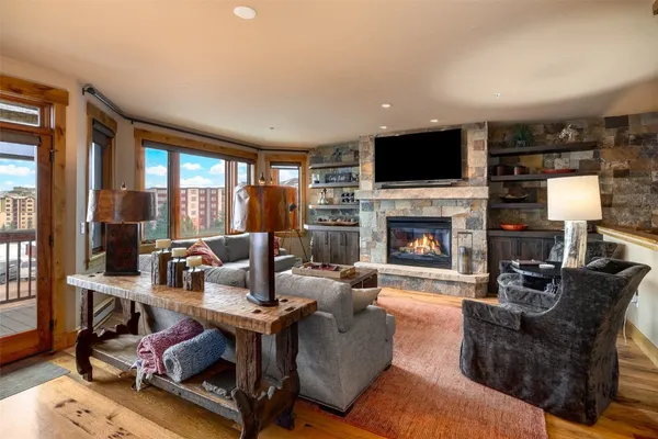 a living room with furniture a flat screen tv and a fireplace