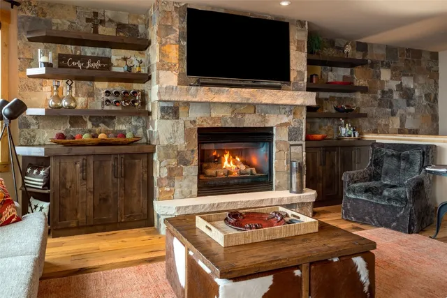 a living room with fireplace and a flat screen tv