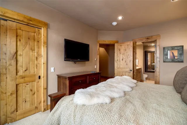 a bathroom with a double vanity sink a toilet and a mirror