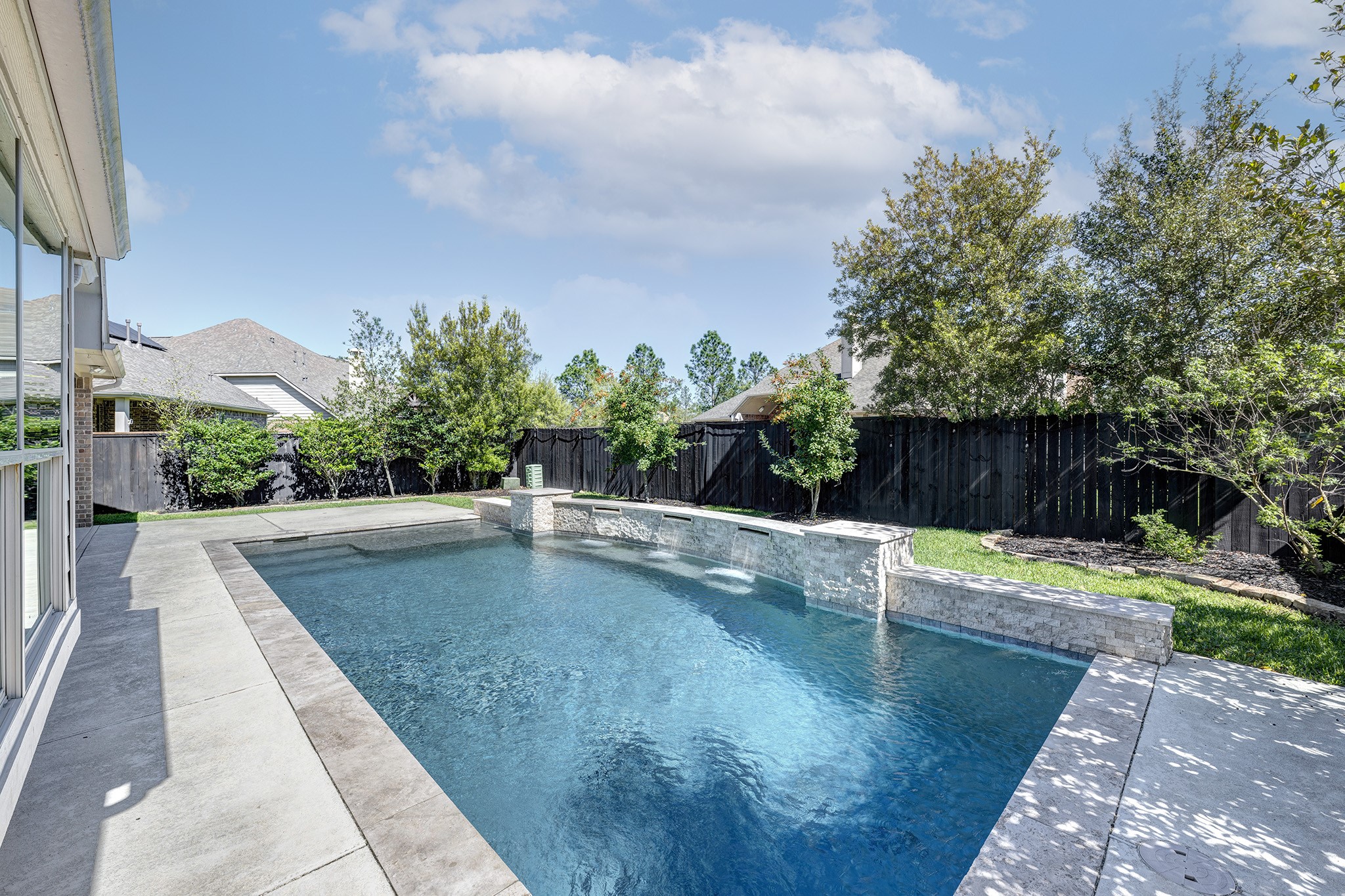 11 Red Wagon Drive Spring, TX 77389 - Photo 1 of 32 Stacked stone waterfalls and "walls" of trees provide a tranquil place to relax.