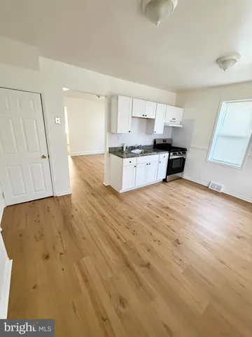 a kitchen with granite countertop a stove and a sink
