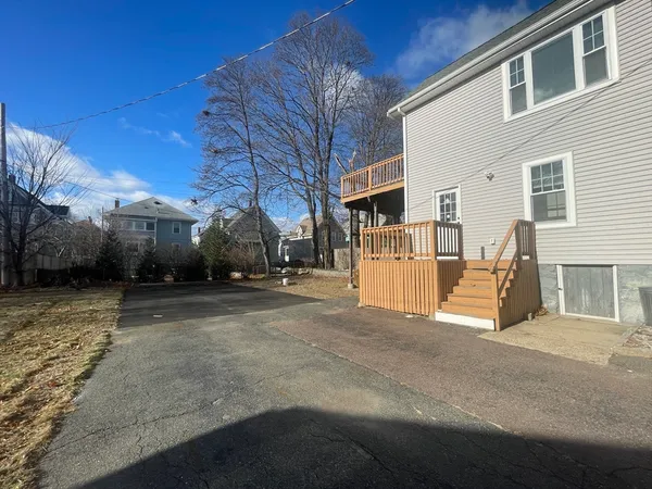 a view of a house with a parking space and a street view