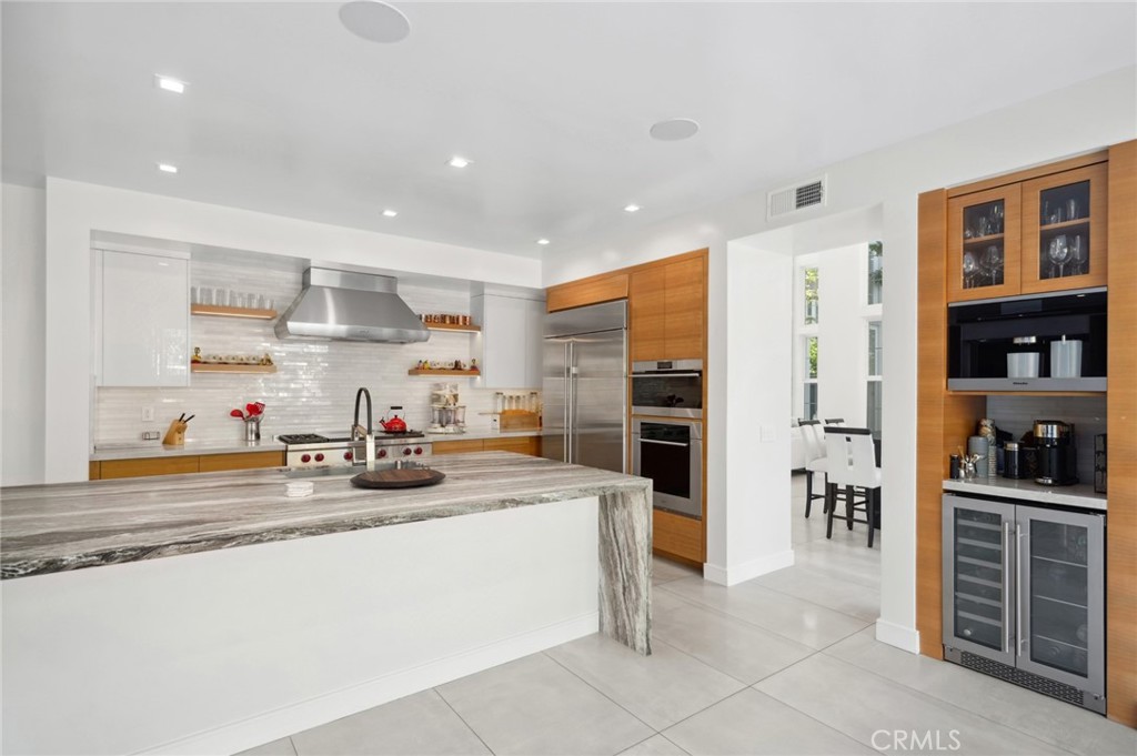3 Bridgeport Road Newport Coast, CA 92657 - Photo 10 of 25 a kitchen with sink refrigerator and cabinets