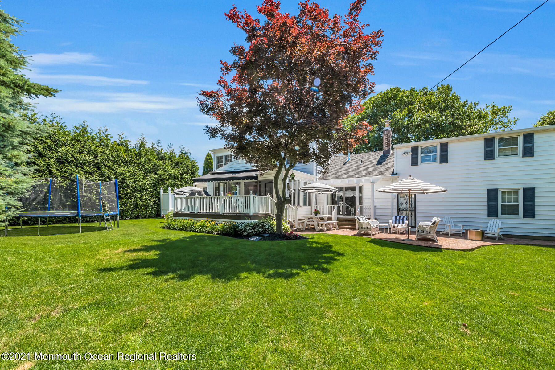 200 Lorraine Avenue Spring Lake, NJ 07762 - Photo 23 of 36 a front view of a house with a garden and trees