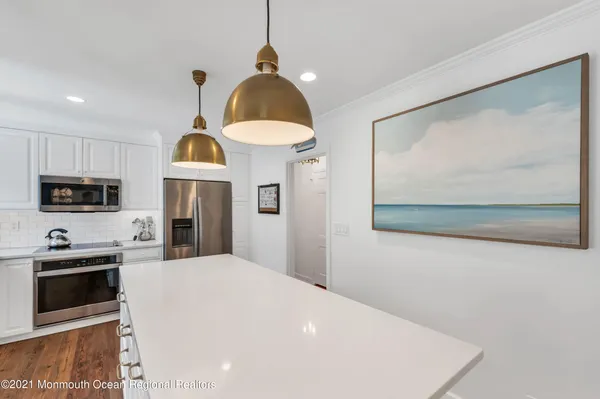 a kitchen with stainless steel appliances a microwave a stove and refrigerator