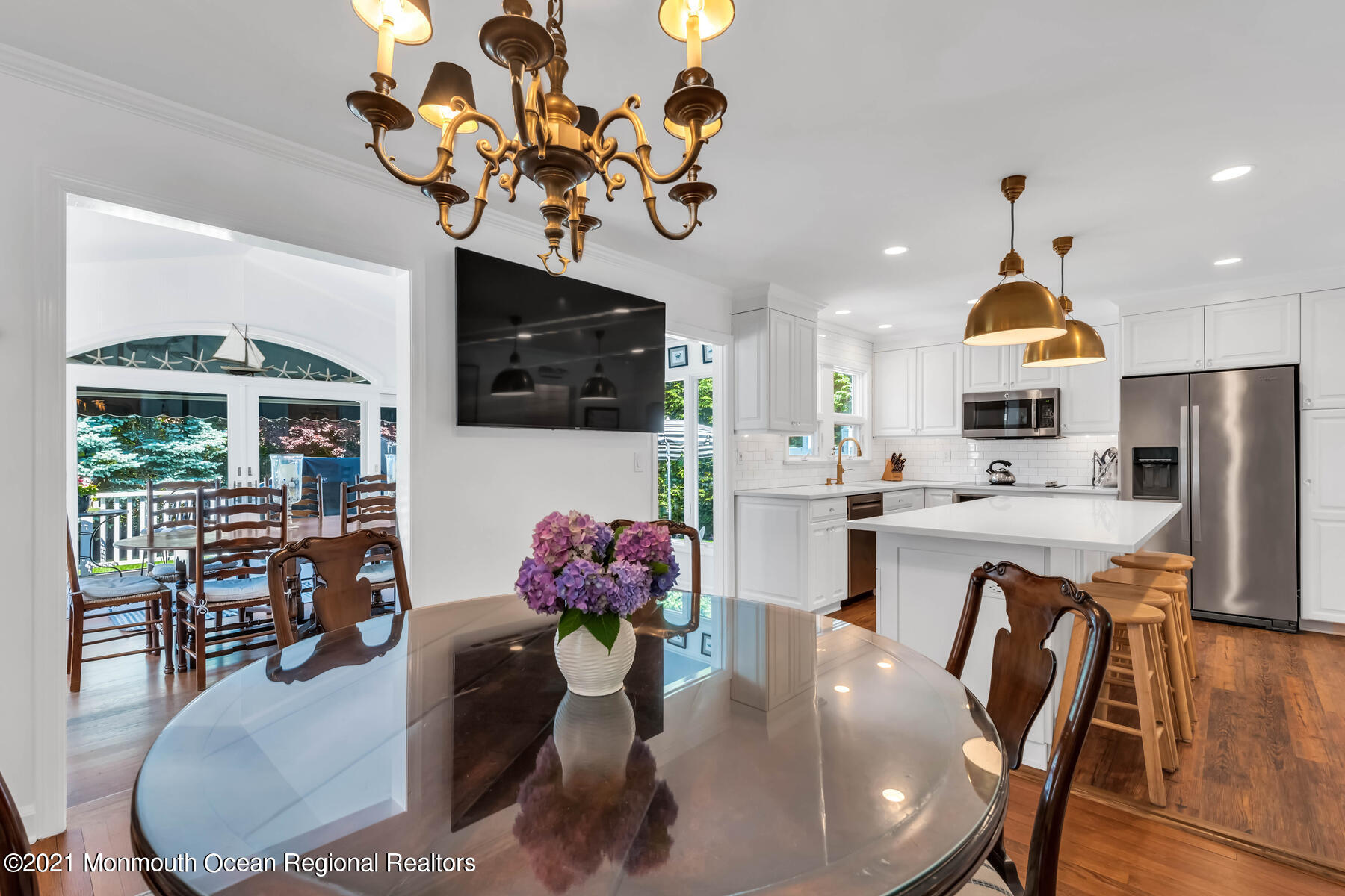 200 Lorraine Avenue Spring Lake, NJ 07762 - Photo 8 of 36 a dining room filled chandelier and kitchen view