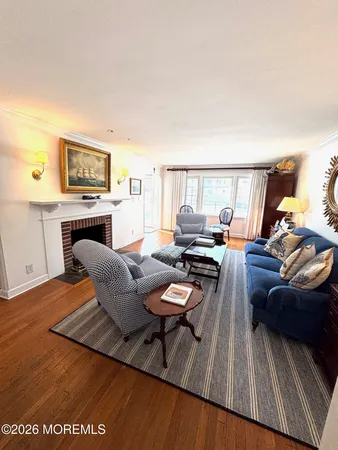 a view of a dining room with furniture a chandelier and wooden floor