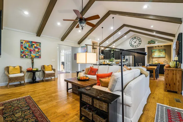 a kitchen with kitchen island stainless steel appliances a stove refrigerator sink and cabinets