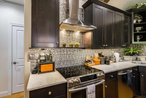 a kitchen with granite countertop a sink stove and cabinets