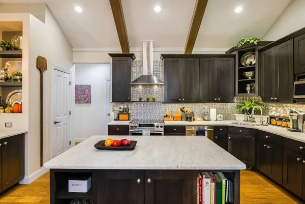 a kitchen with sink a stove and cabinets