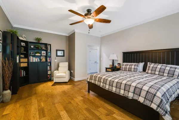 a bedroom with a bed and ceiling fan