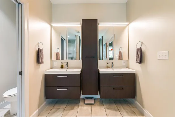 a spacious bathroom with a double vanity sink and mirror