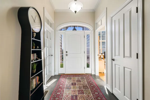 a view of a hallway with wooden floor and staircase