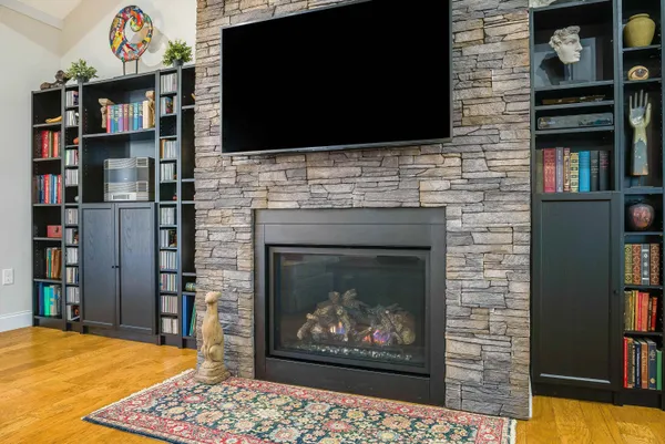 a living room with a fireplace and a flat screen tv