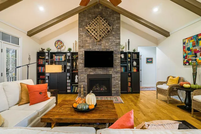a living room with furniture and a clock