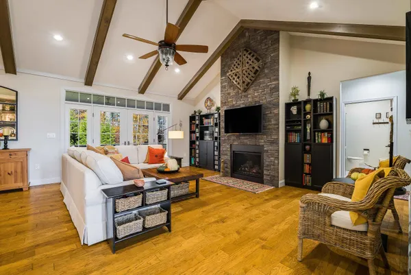 a living room with furniture a fireplace and a flat screen tv