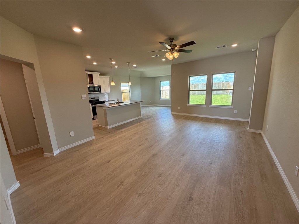 6117 Eldora Drive College Station, TX 77845 - Photo 5 of 8 Unfurnished living room featuring recessed lighting, light wood finished floors, and a ceiling fan