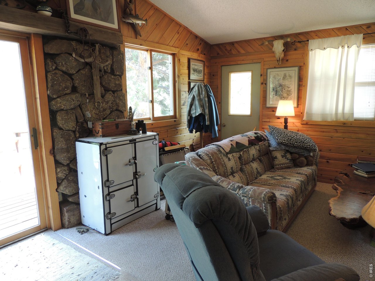 2300 Red Ashby Road Livermore, CO 80536 - Photo 13 of 32 Living room, deck slider door on left